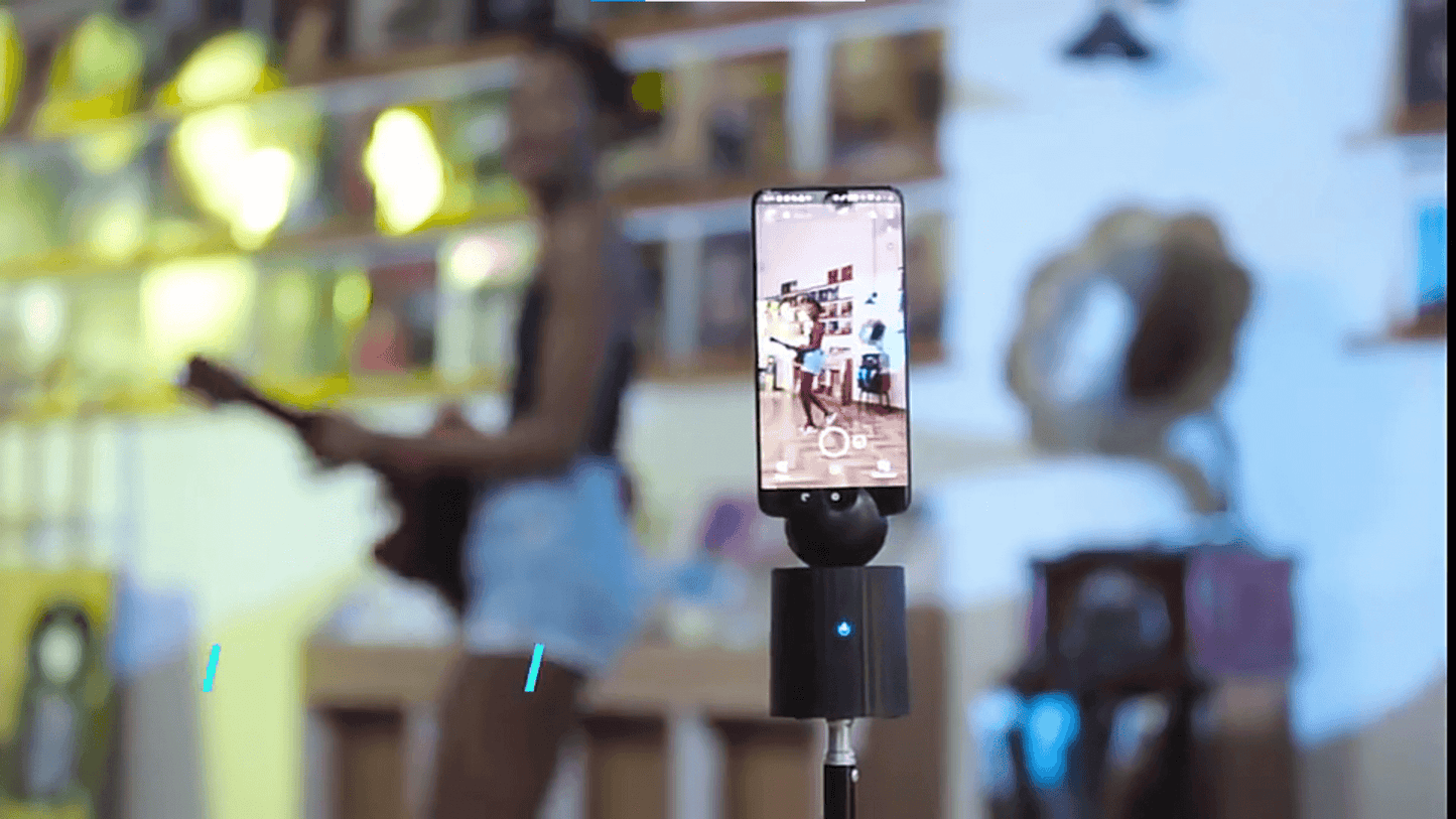 A black auto object tracking phone holder sold by WorkZen Interiors