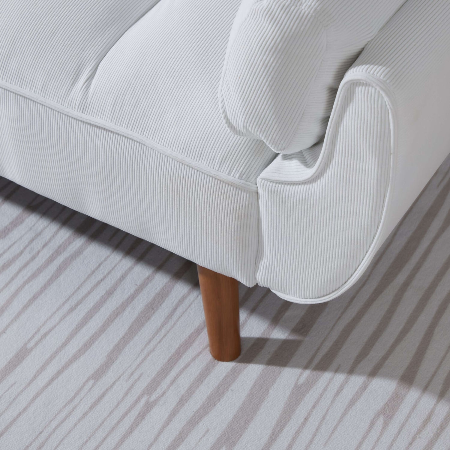 The wooden leg of a Boston White Chair Sofa Bed sold by WorkZen Interiors