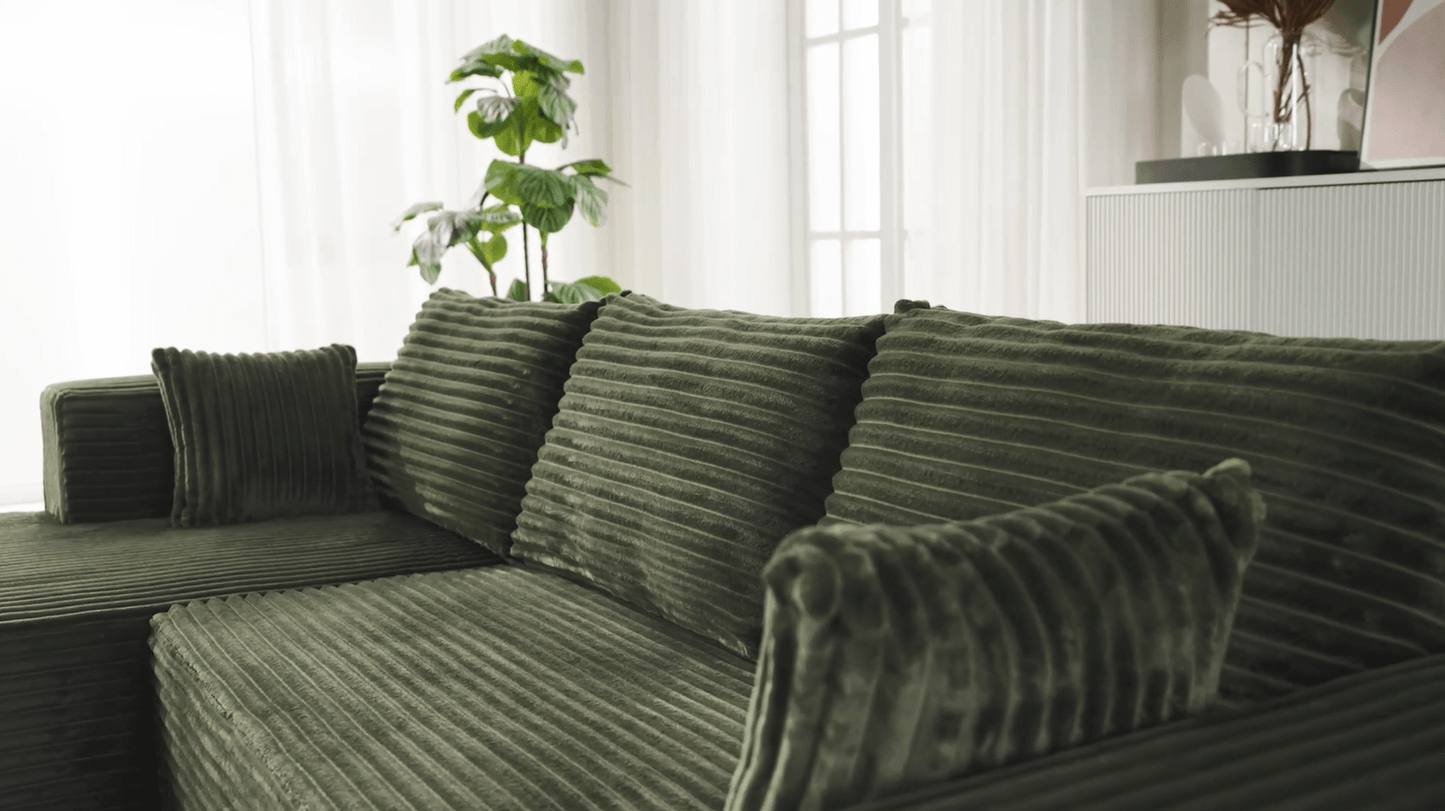 A green sectional sofa sold by WorkZen Interiors