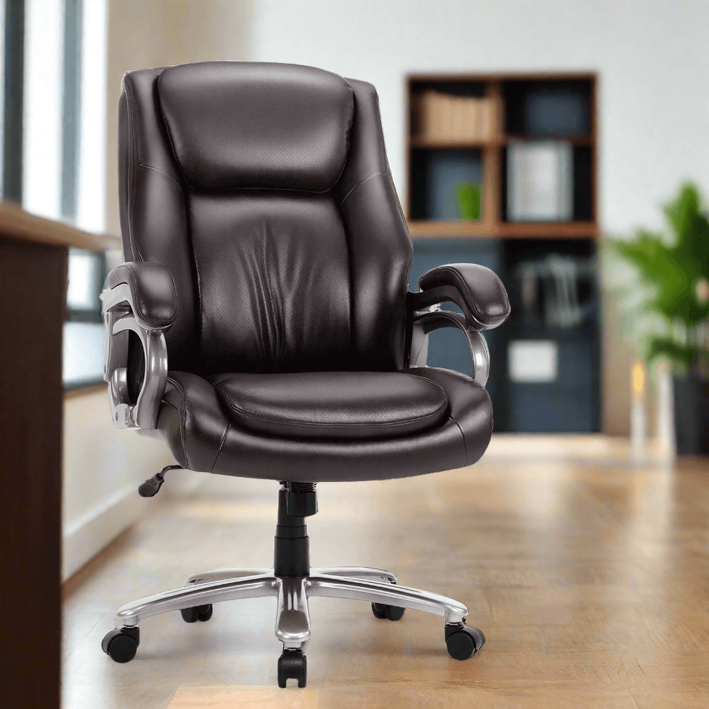 A brown high back office chair sold by WorkZen Interiors in an office with a table in front of it, a book shelf behind it and a green plant in the background.