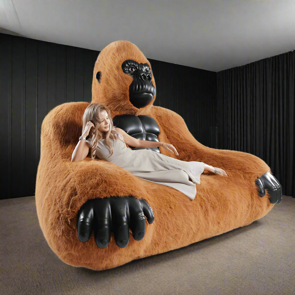 A brown inflatable gorilla sofa sold by WorkZen Interiors with a beautiful woman lying on it.
