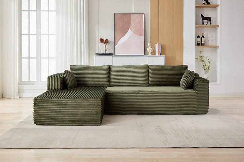 A green sectional sofa sold by WorkZen Interiors