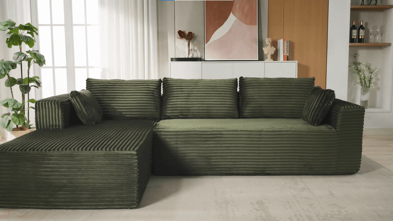 A green sectional sofa sold by WorkZen Interiors