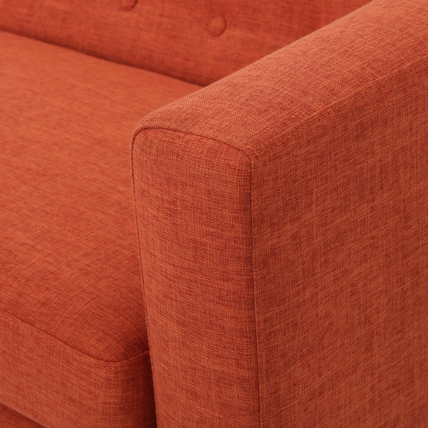 The armrest of an orange lounger sofa sold by WorkZen Interiors