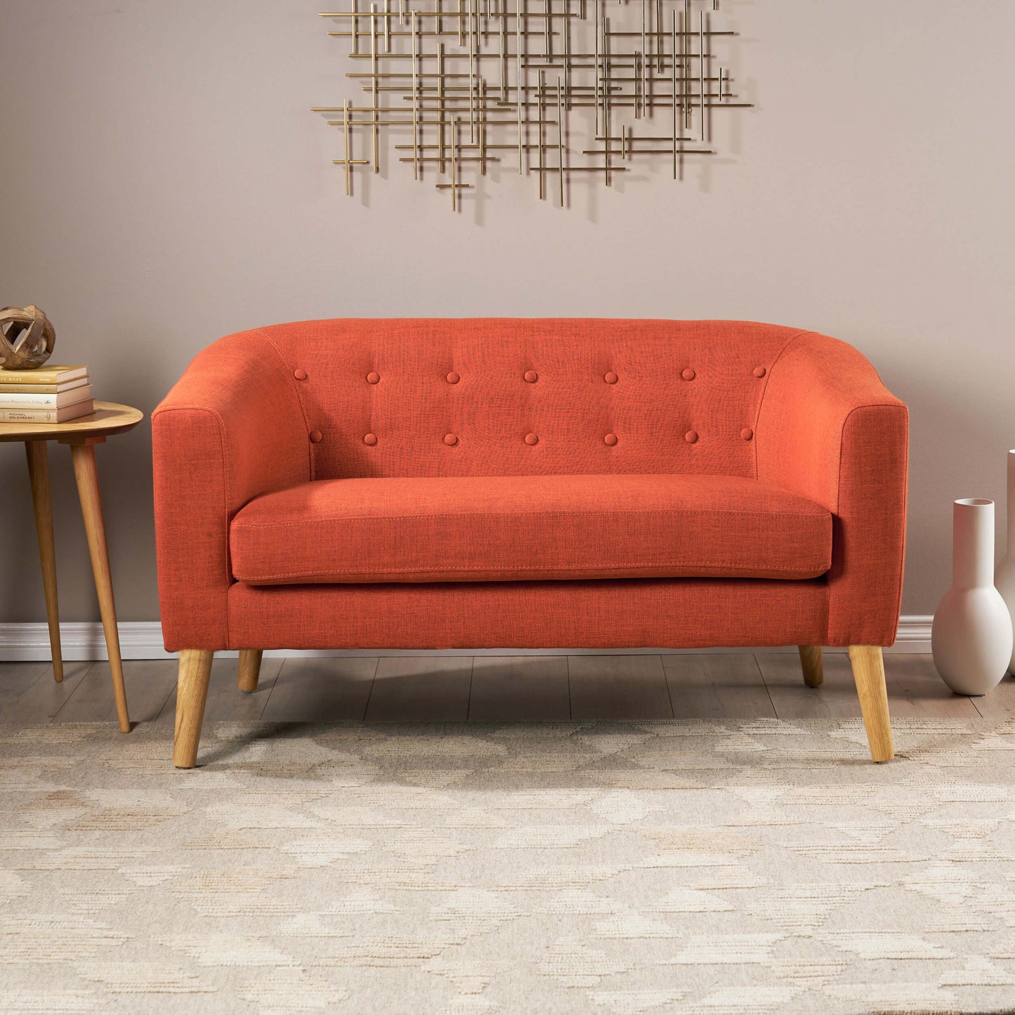 The front of an orange lounger sofa sold by WorkZen Interiors