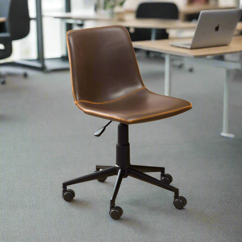 A swiveling office chair in an open office layout with different desk with laptops on top of them and other chairs