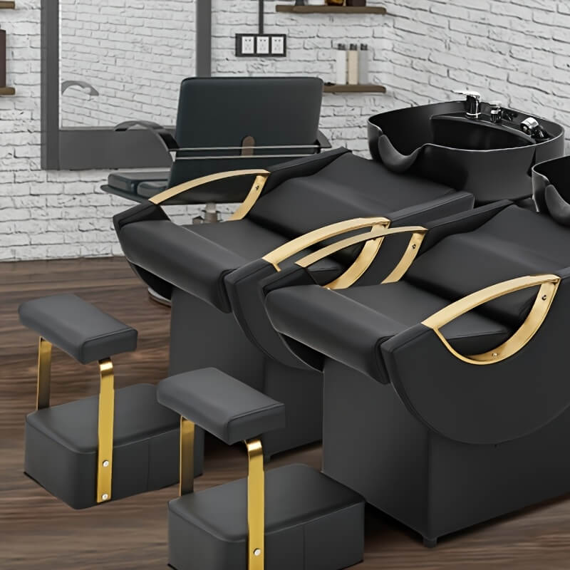 Black and gold hair salon backwash units with a white brick wall background