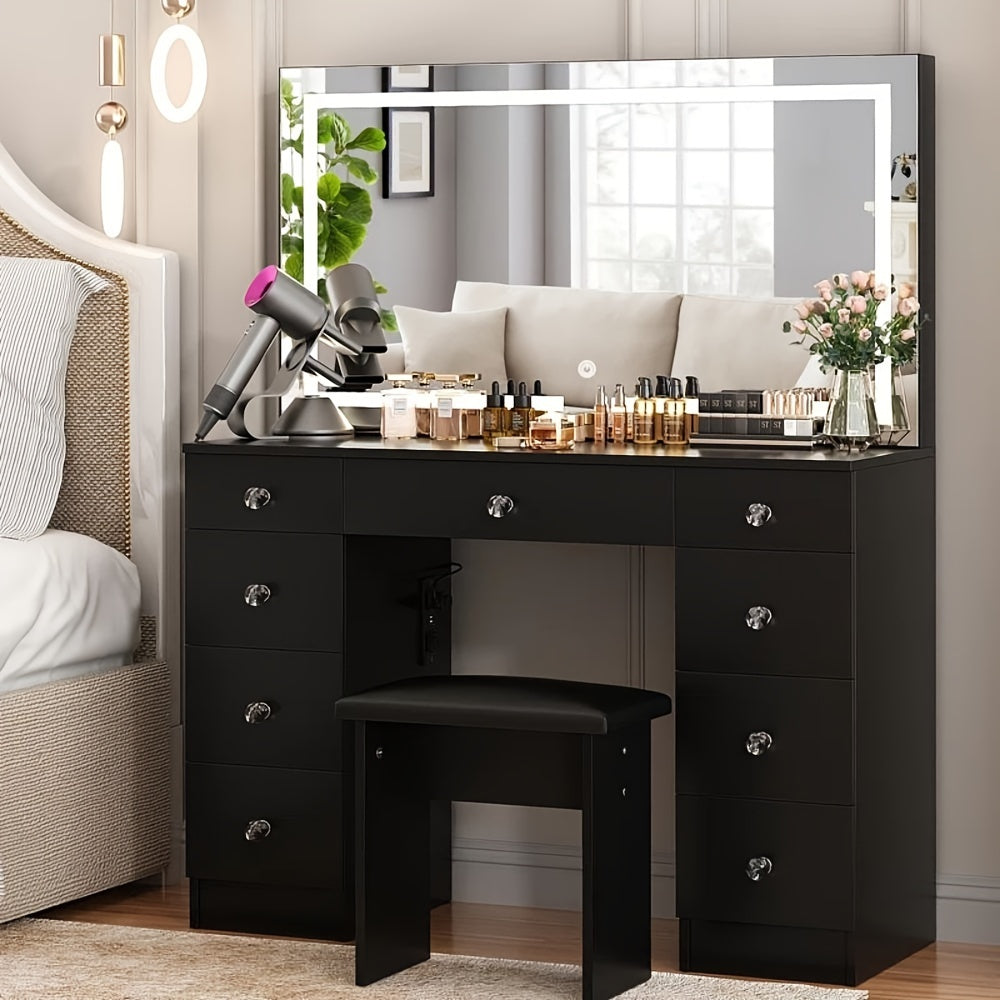Black vanity desk with makeup items and a stool in a bedroom setting.