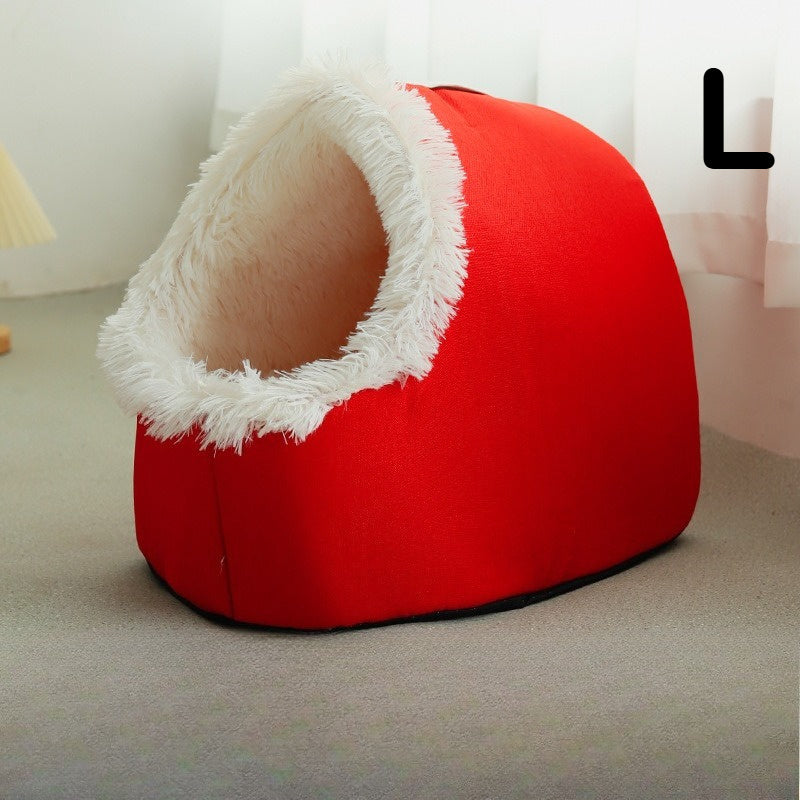 Red cat cave bed with white interior on a light-colored floor