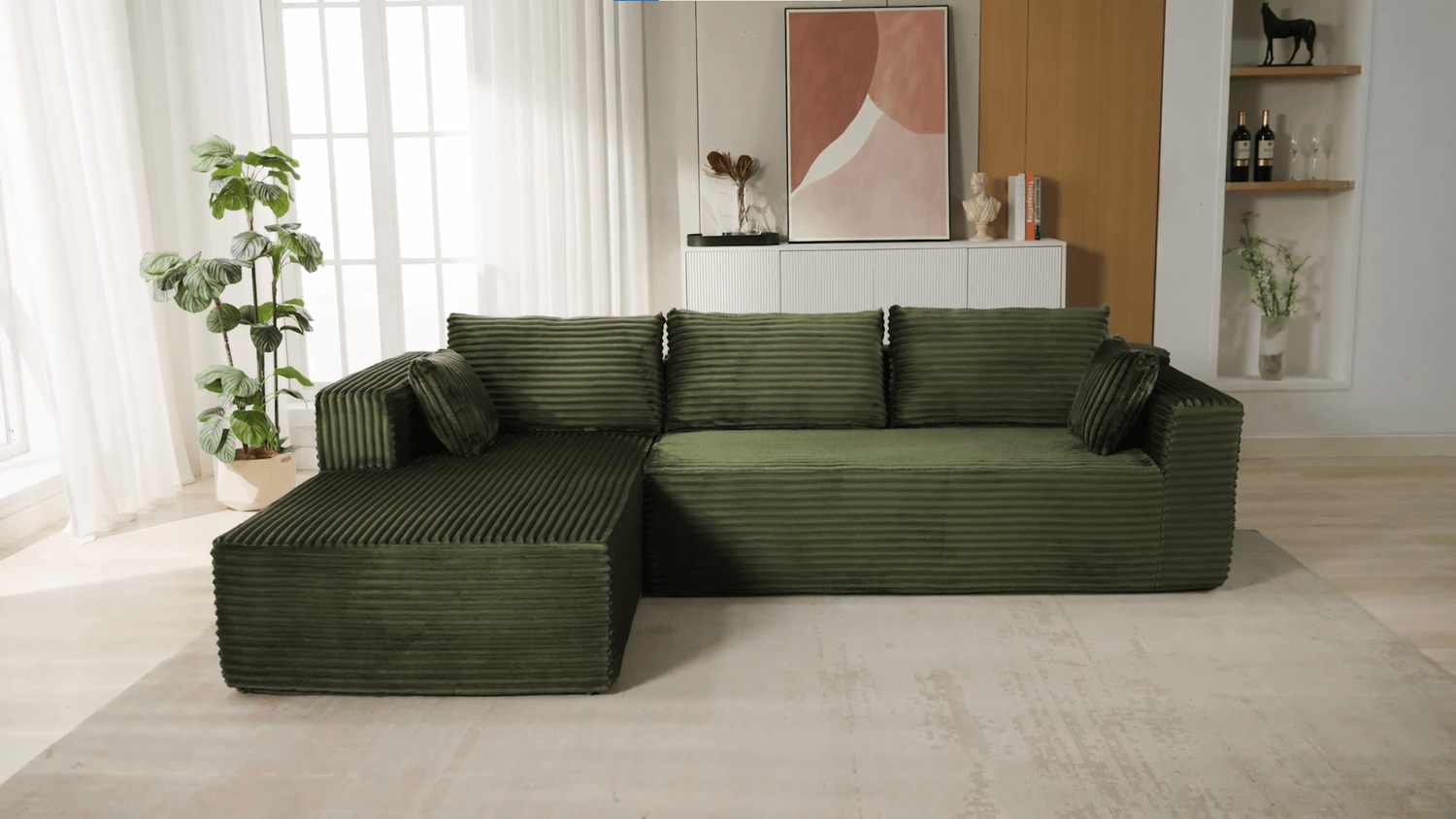 A green sectional sofa sold by WorkZen Interiors
