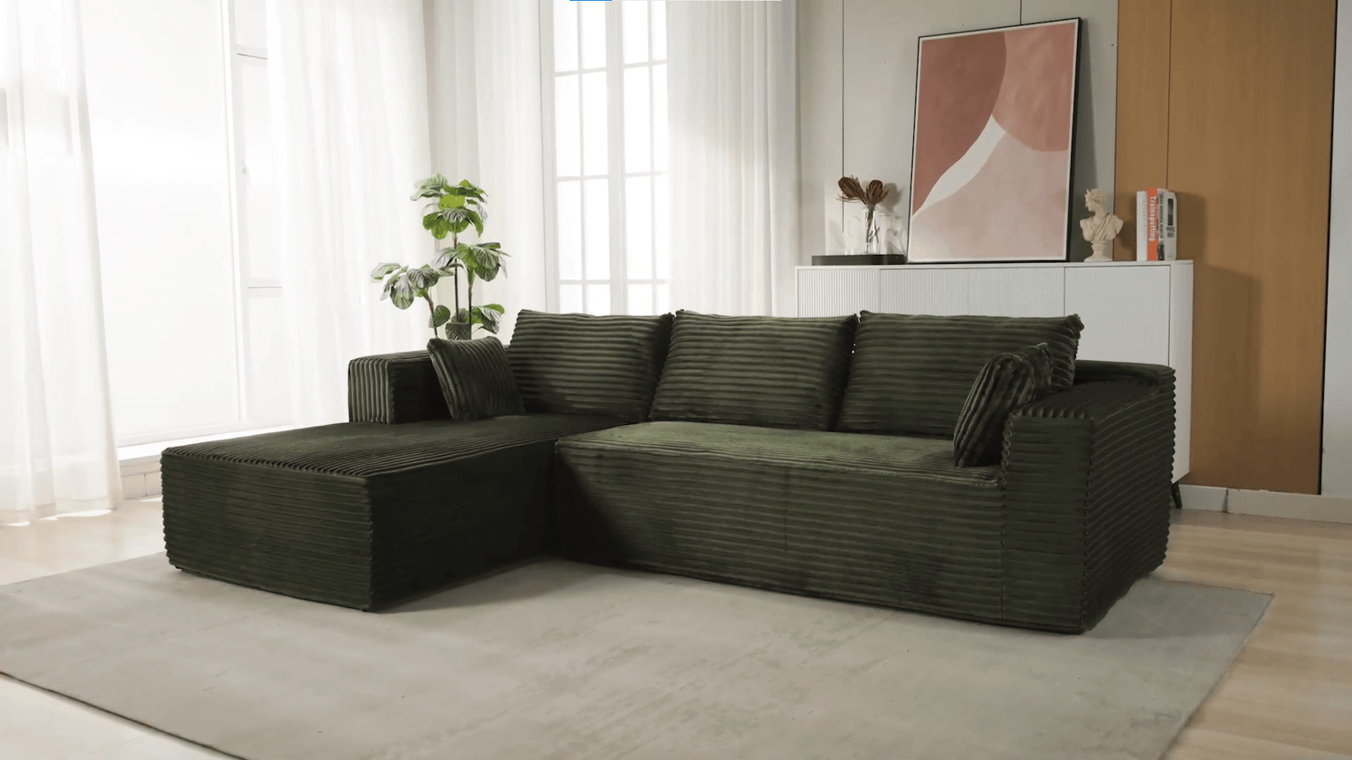 A green sectional sofa sold by WorkZen Interiors