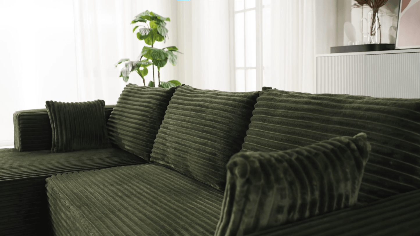 A green sectional sofa sold by WorkZen Interiors