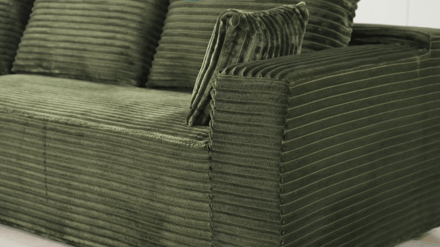 A green sectional sofa sold by WorkZen Interiors