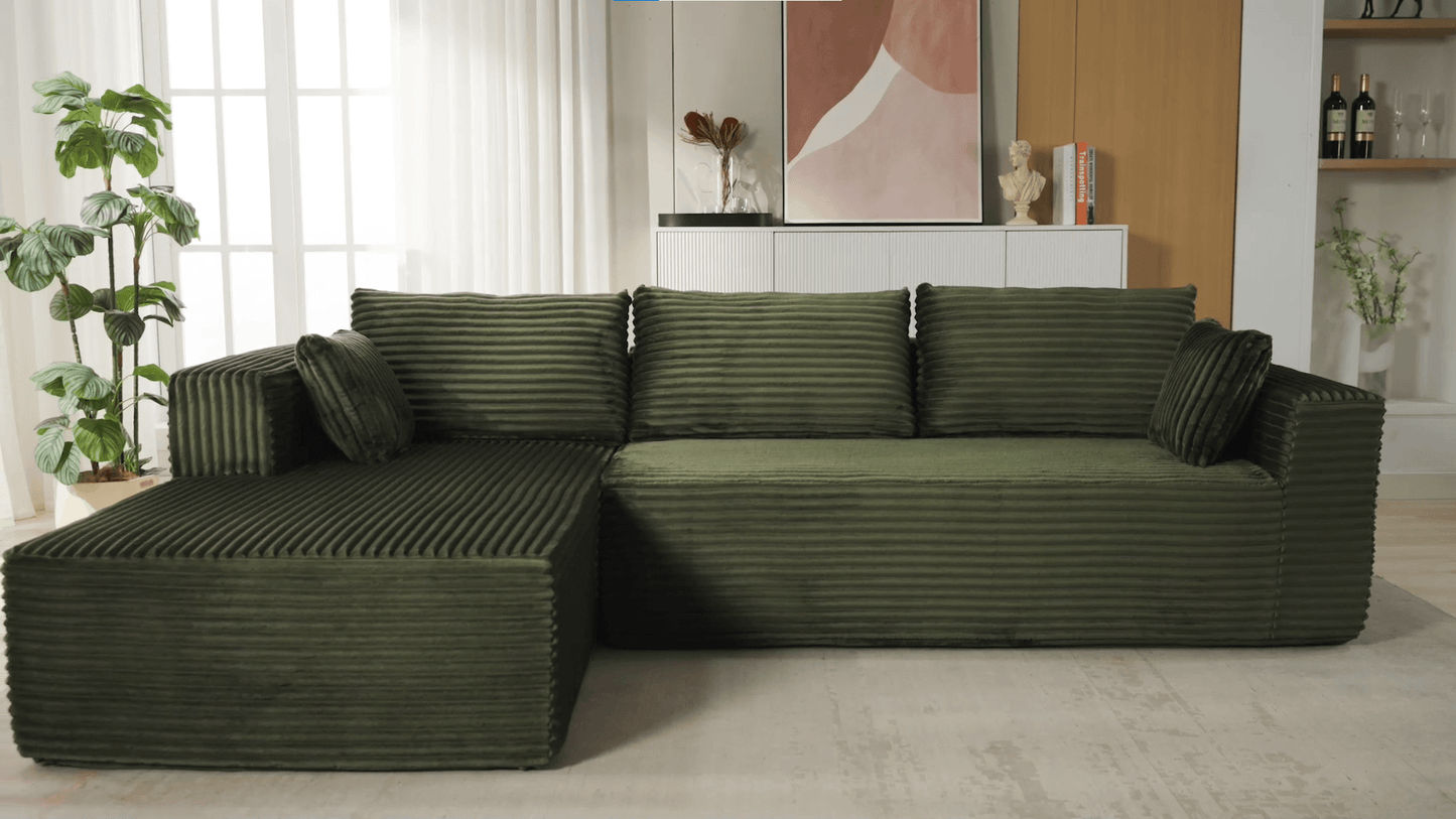 A green sectional sofa sold by WorkZen Interiors
