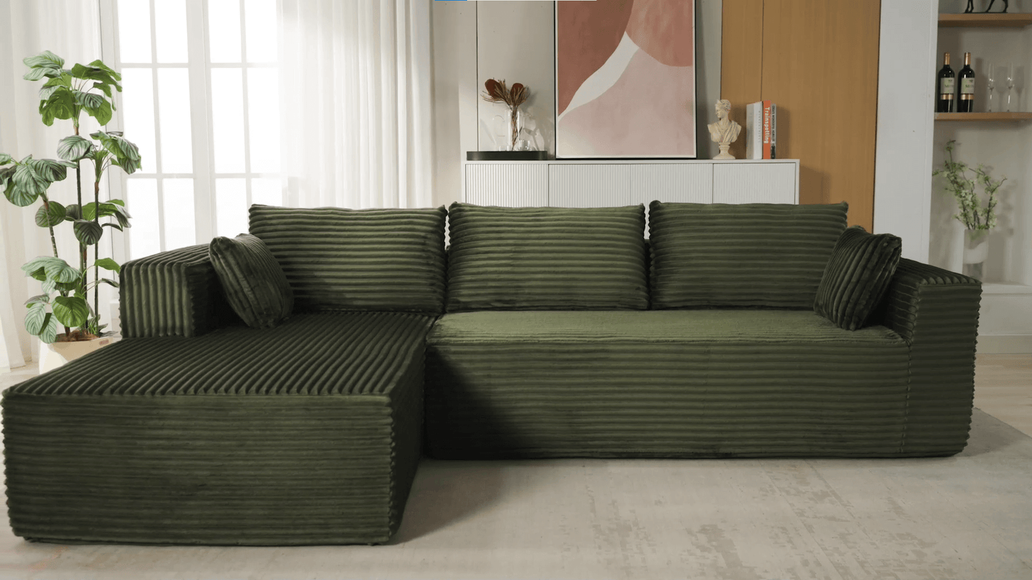 A green sectional sofa sold by WorkZen Interiors