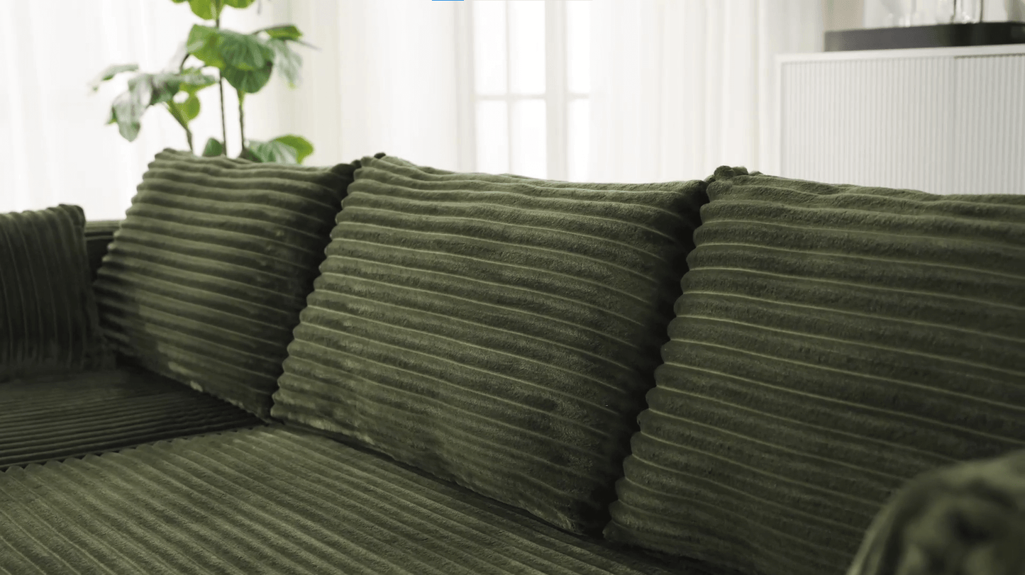 A green sectional sofa sold by WorkZen Interiors