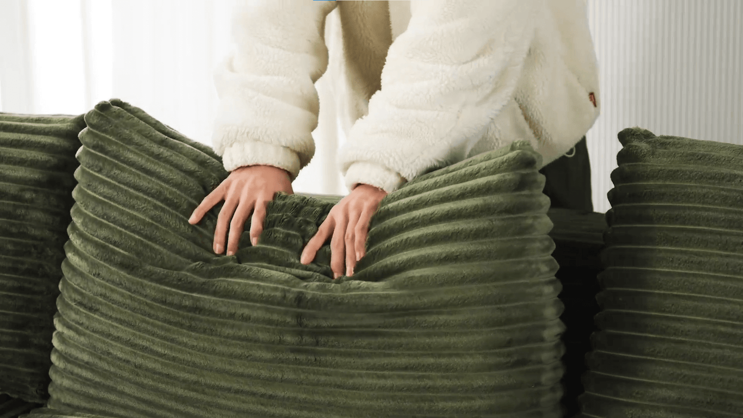 A green sectional sofa sold by WorkZen Interiors