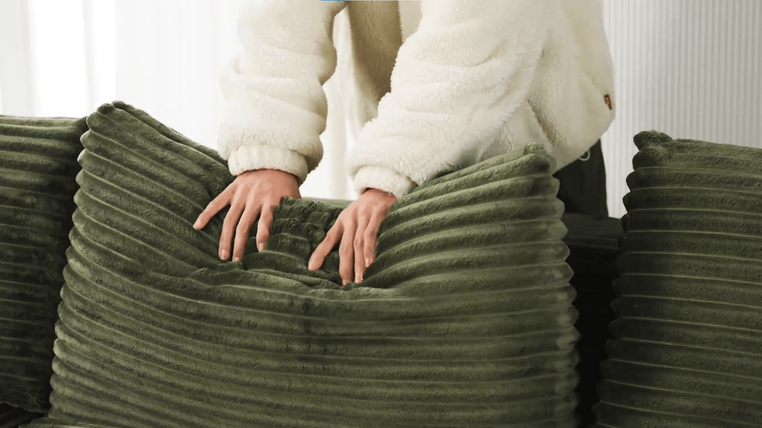 A green sectional sofa sold by WorkZen Interiors