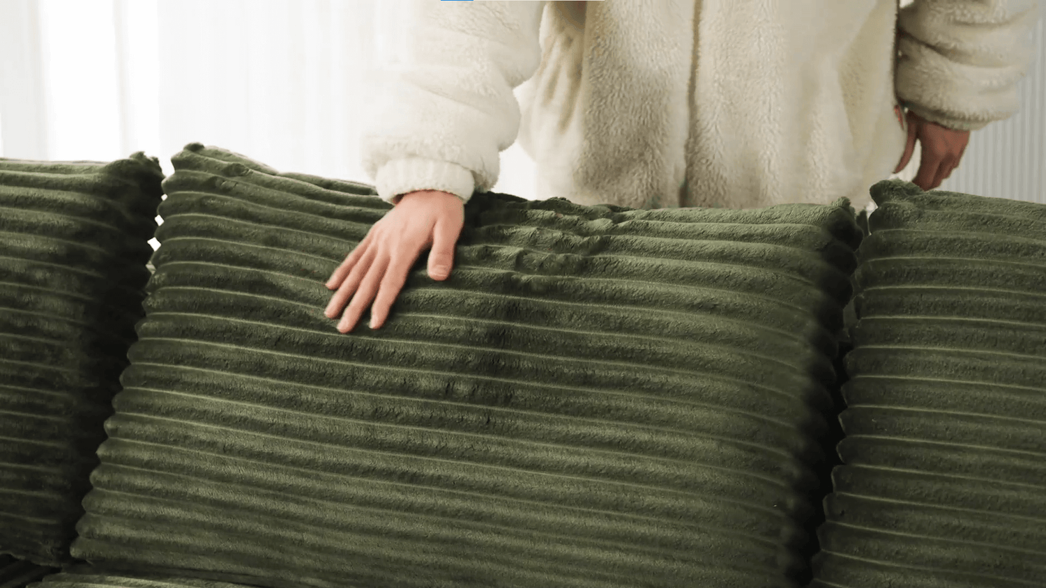 A green sectional sofa sold by WorkZen Interiors