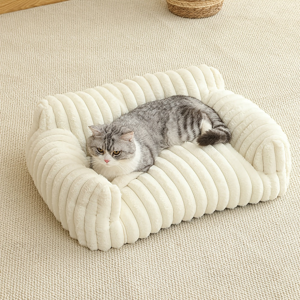 Cat lying on a plush, white cat sofa on a beige carpet