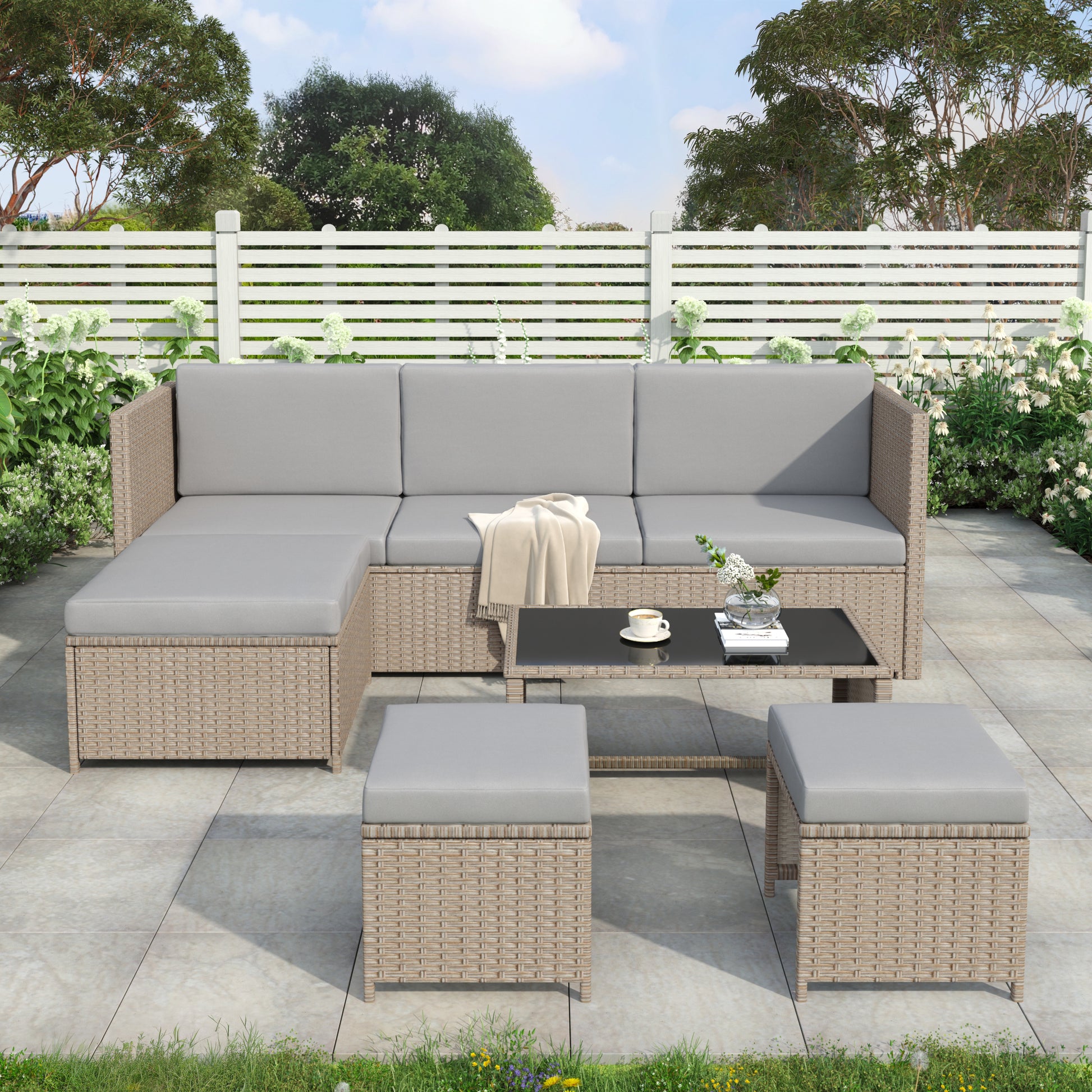 Contemporary rattan sofa set with sectional sofa and coffee table on a patio.