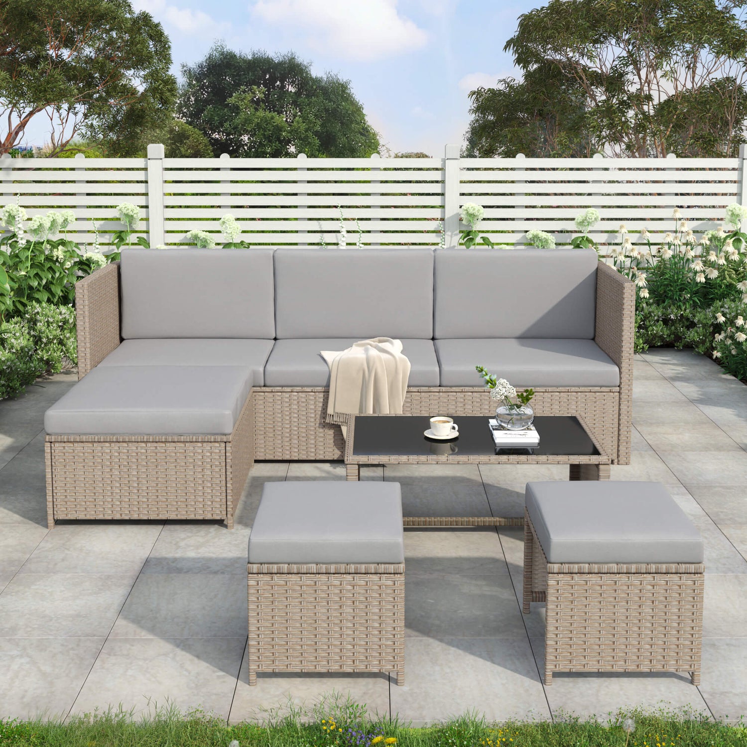 Outdoor patio furniture set with sectional sofa and coffee table on a patio.