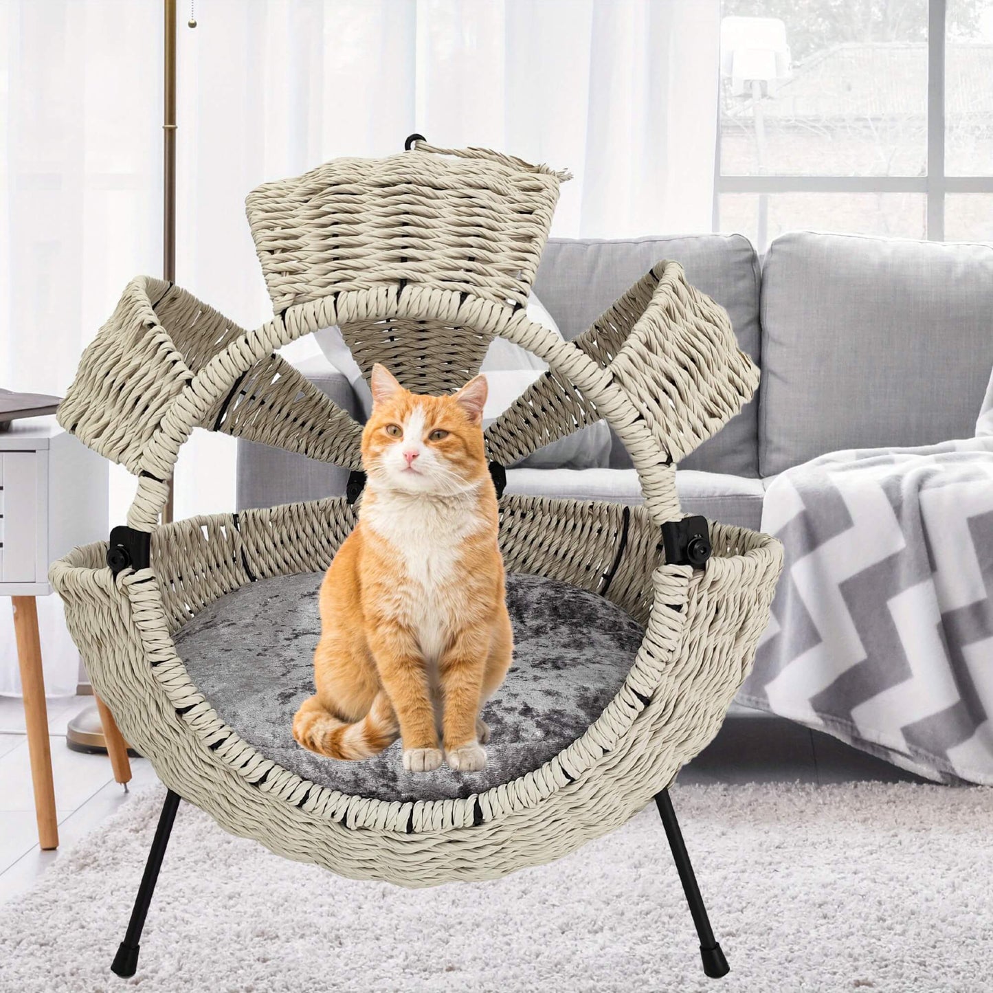 Cat sitting on a multi-level wicker cat tree in a living room.