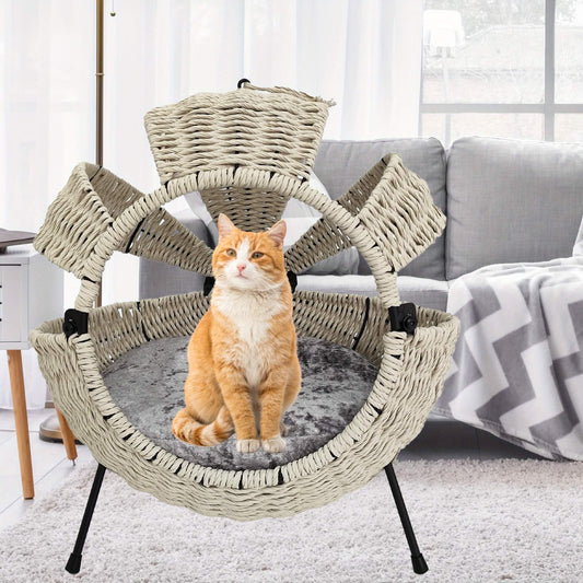 Cat sitting on a multi-level wicker cat tree in a living room.