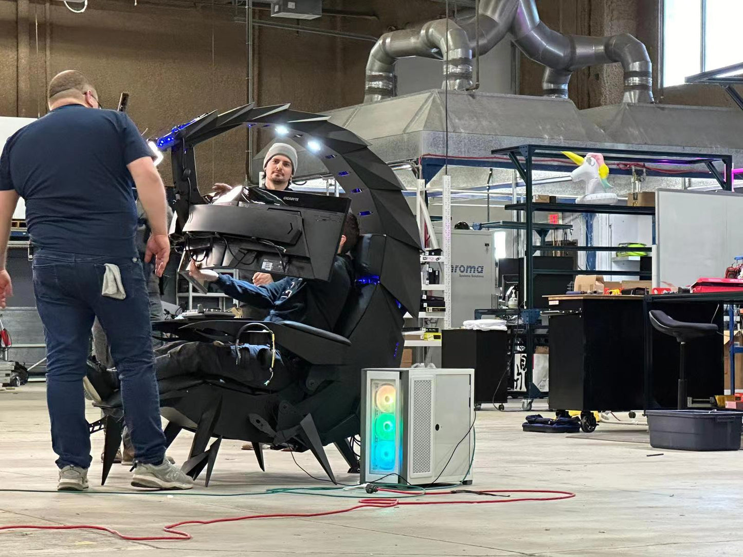 2 people that just finished installing a Cluven scorpion gaming cockpit
