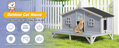 Outdoor cat house with a cat peeking out, surrounded by grass and a white fence.