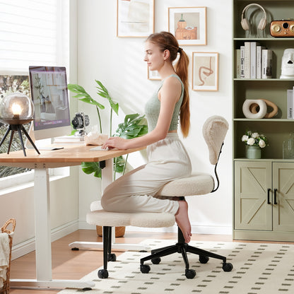 Woman sitting on a kneeling chair at a desk in a home office setting.