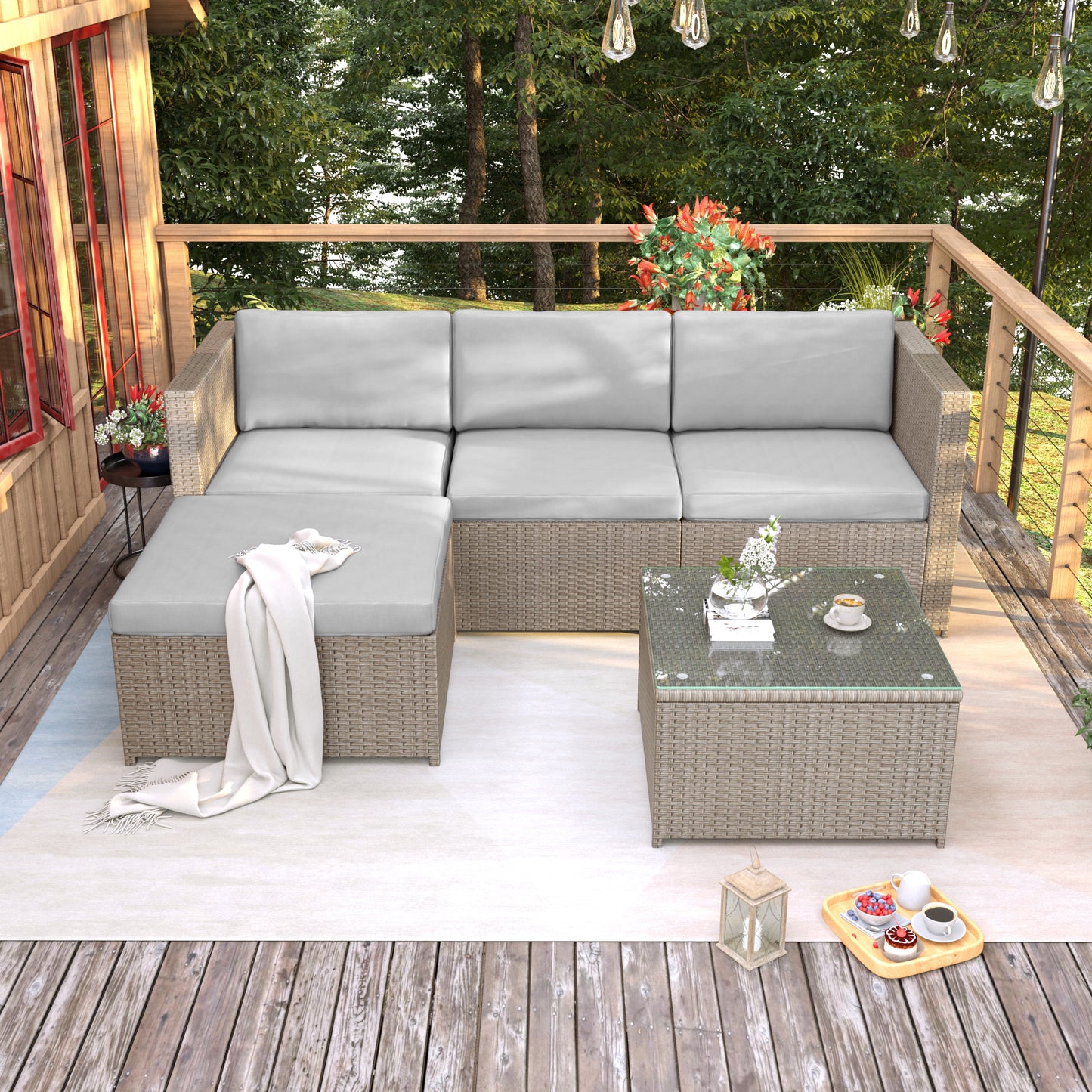 Outdoor patio furniture set with a glass-top table on a wooden deck.