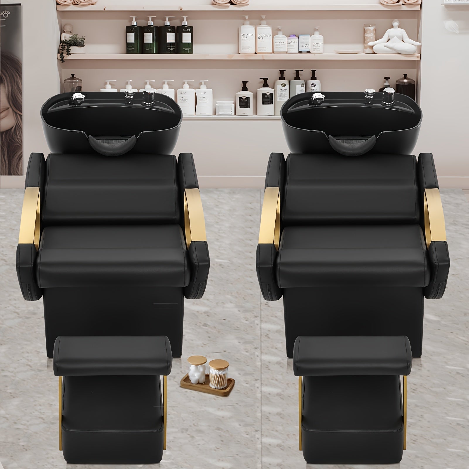 Two black salon backwash units with shampoo basins in a salon setting.