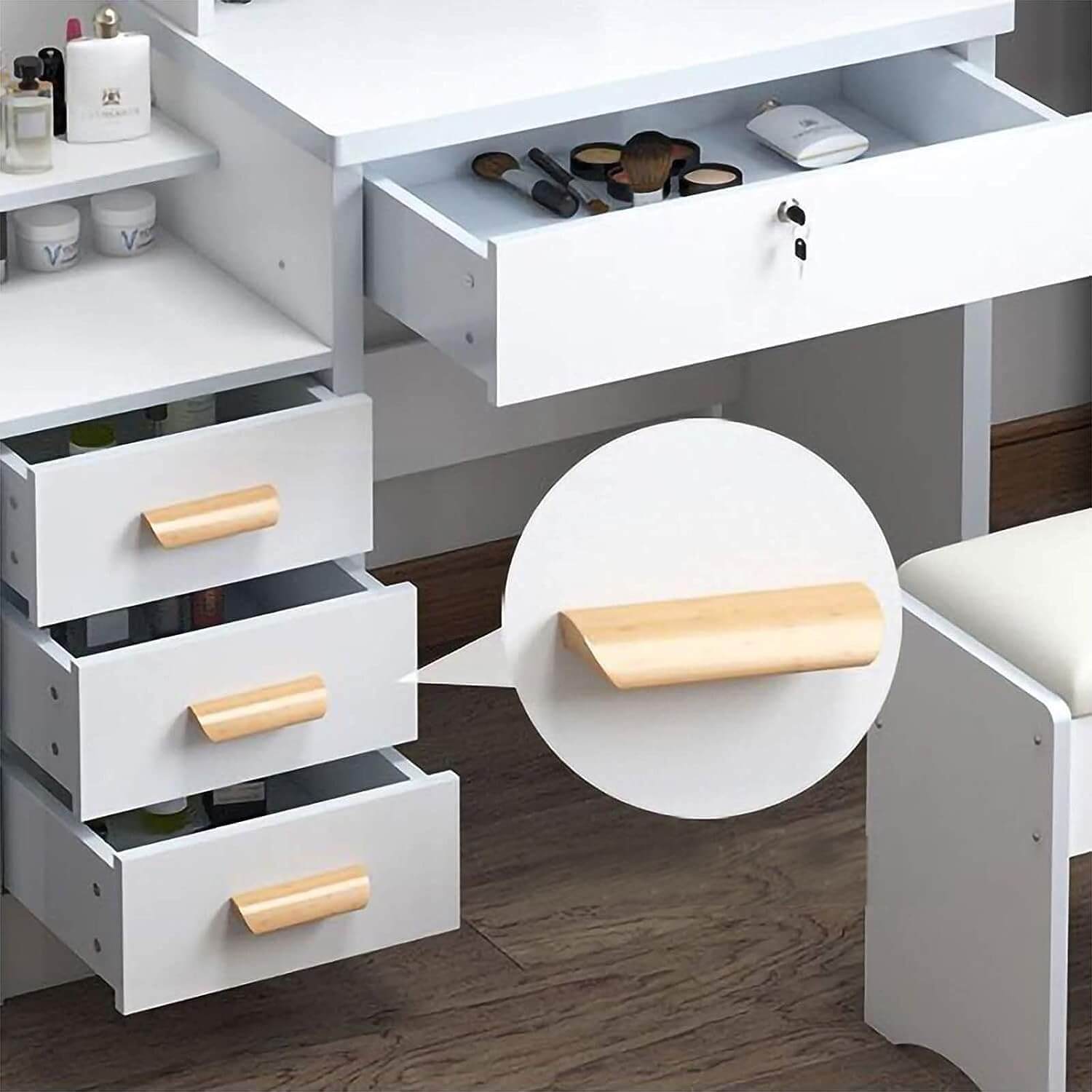 White vanity desk set with open drawers and a close-up of a wooden handle.