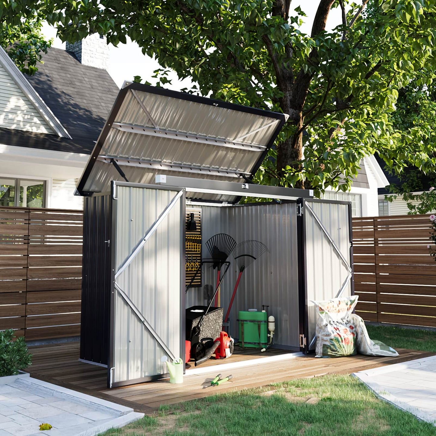 Metal garden shed with open door on a wooden deck, surrounded by greenery.