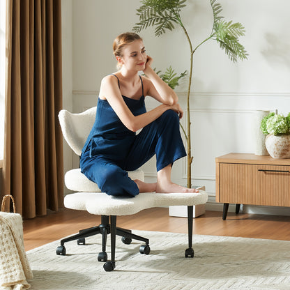 Woman in a blue outfit sitting on a white office chair in a home office setting.