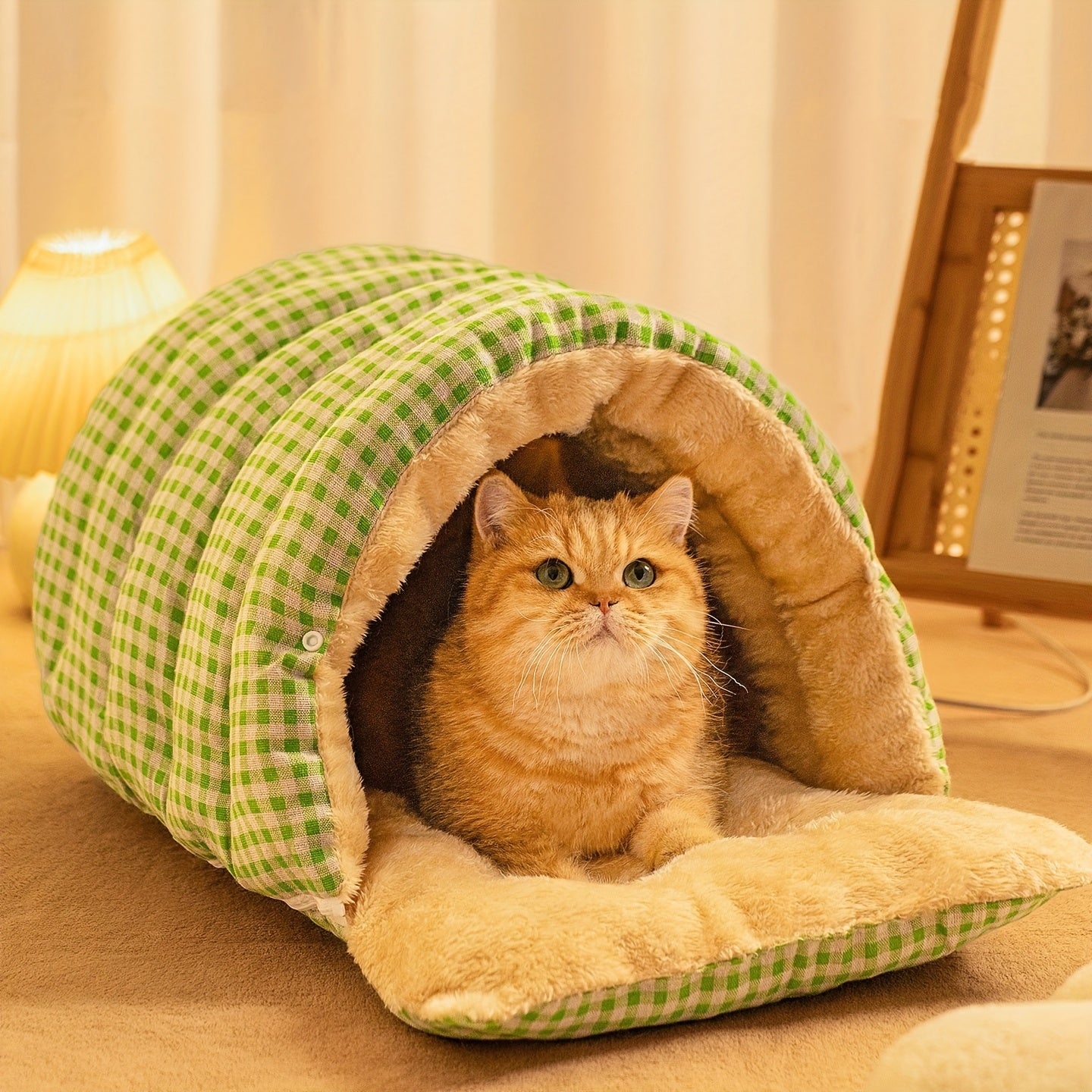 Cat peeking out from a green and beige checkered wool cat cave on a soft surface.