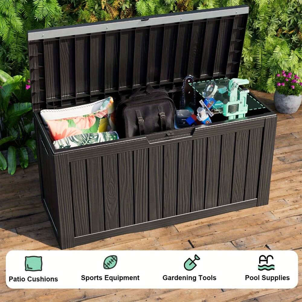 Outdoor storage bench with items on a wooden deck, surrounded by greenery.