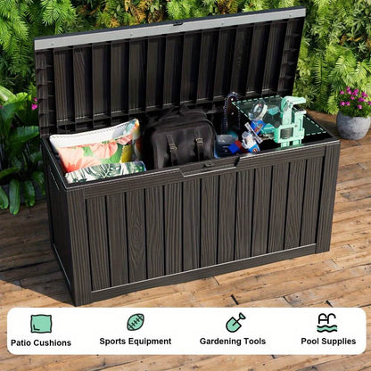 Outdoor storage bench with items on a wooden deck, surrounded by greenery.