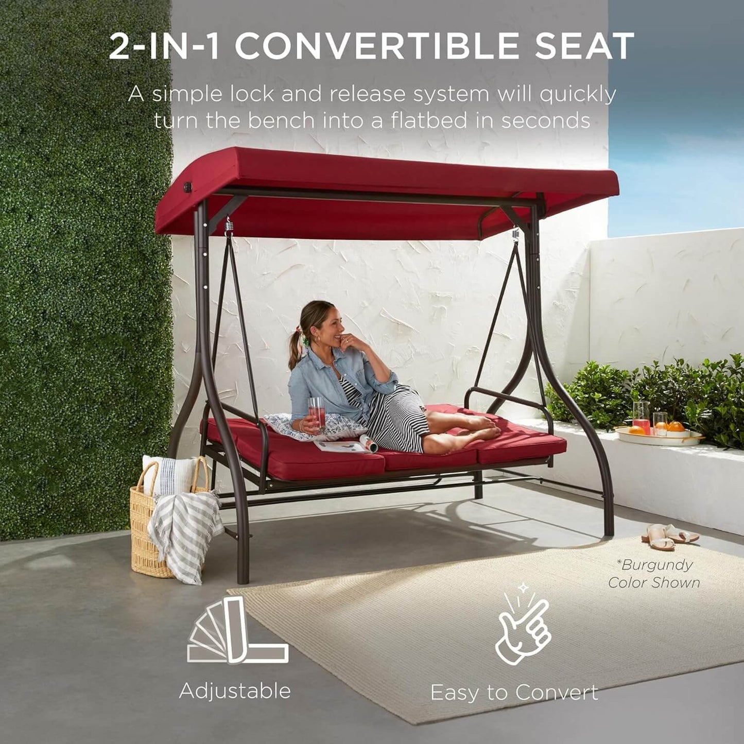 2-in-1 convertible seat with red canopy and cushions, woman sitting on it outdoors.
