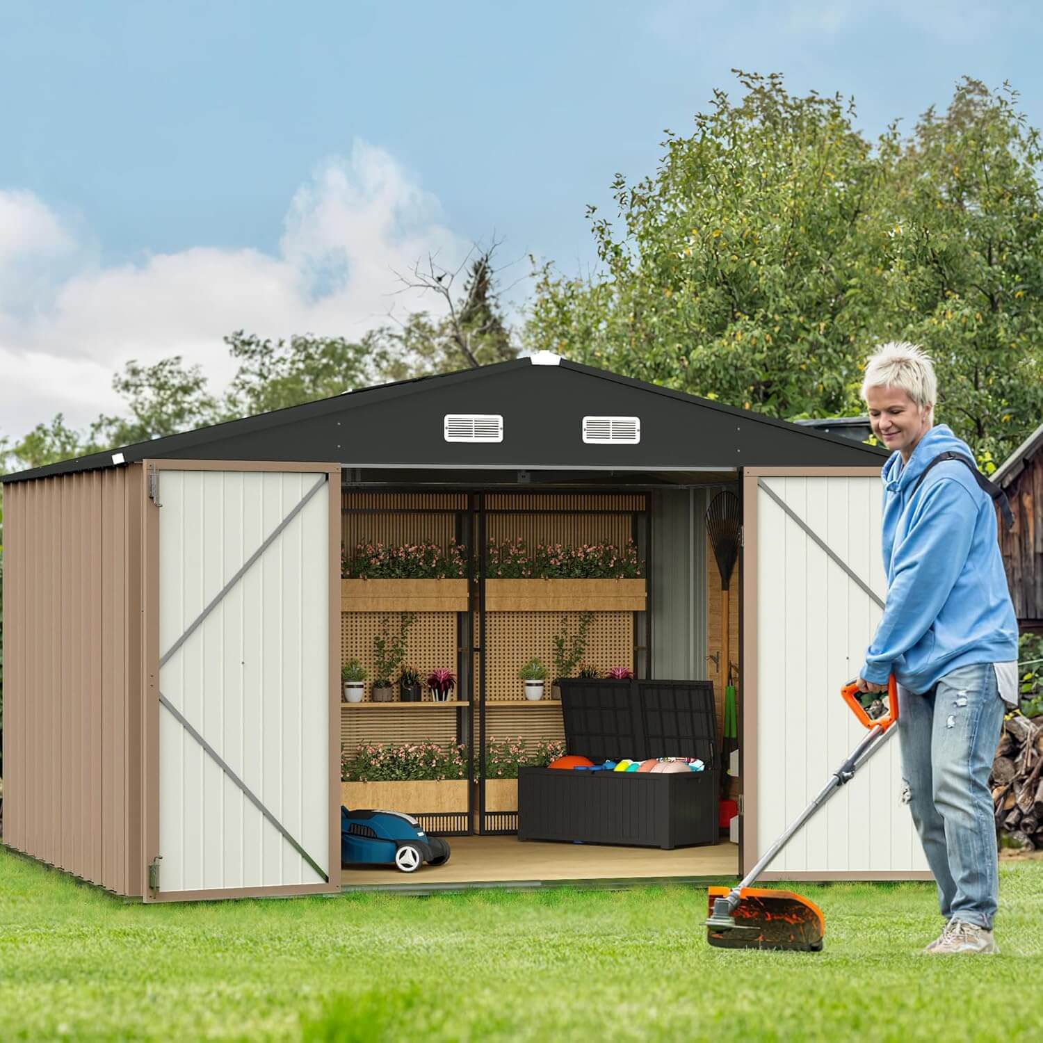 Person using a lawn mower in front of a large storage shed with garden items inside.