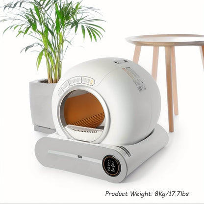 White smart scoop cat litter box with orange interior on a white background, next to a plant and small table.