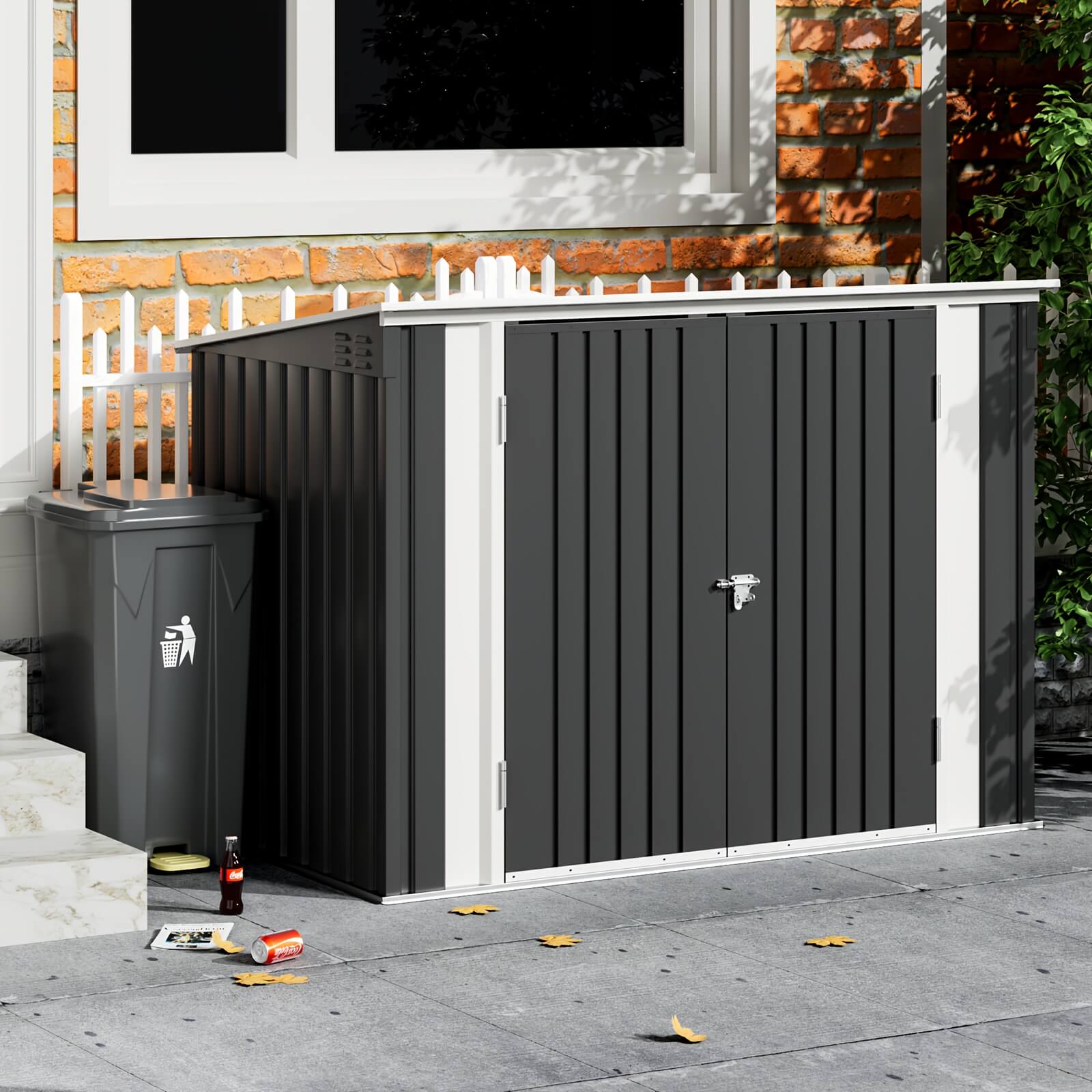 Gray outdoor storage shed with a door next to a trash bin on a patio.