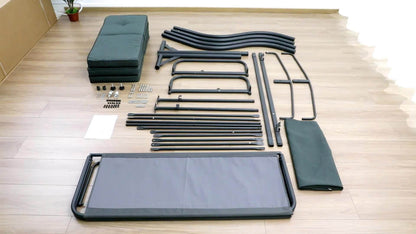 Components of a bed frame laid out on a wooden floor