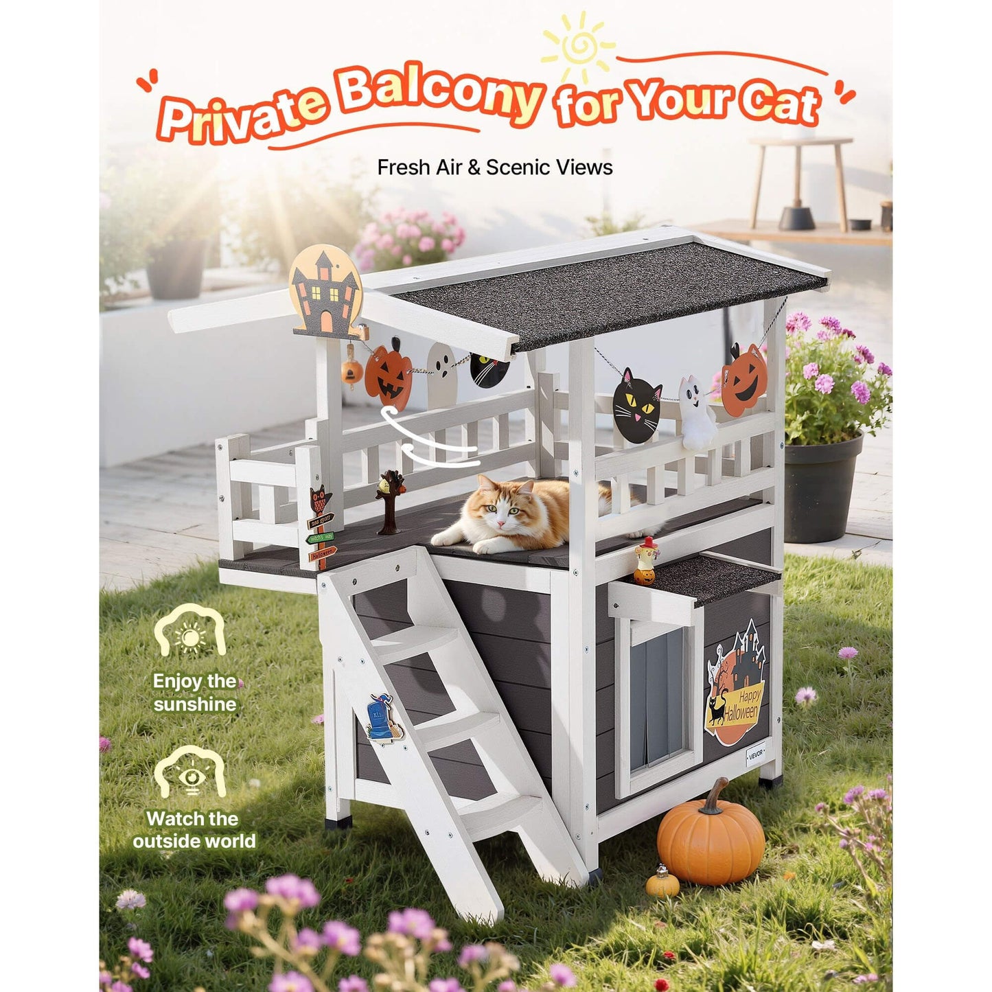 Feral cat outdoor shelter with a cat on a grassy area, surrounded by flowers and pumpkins.