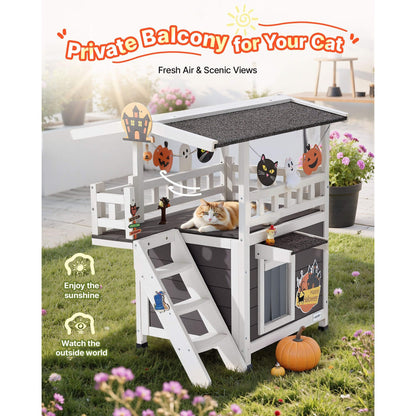 Feral cat outdoor shelter with a cat on a grassy area, surrounded by flowers and pumpkins.