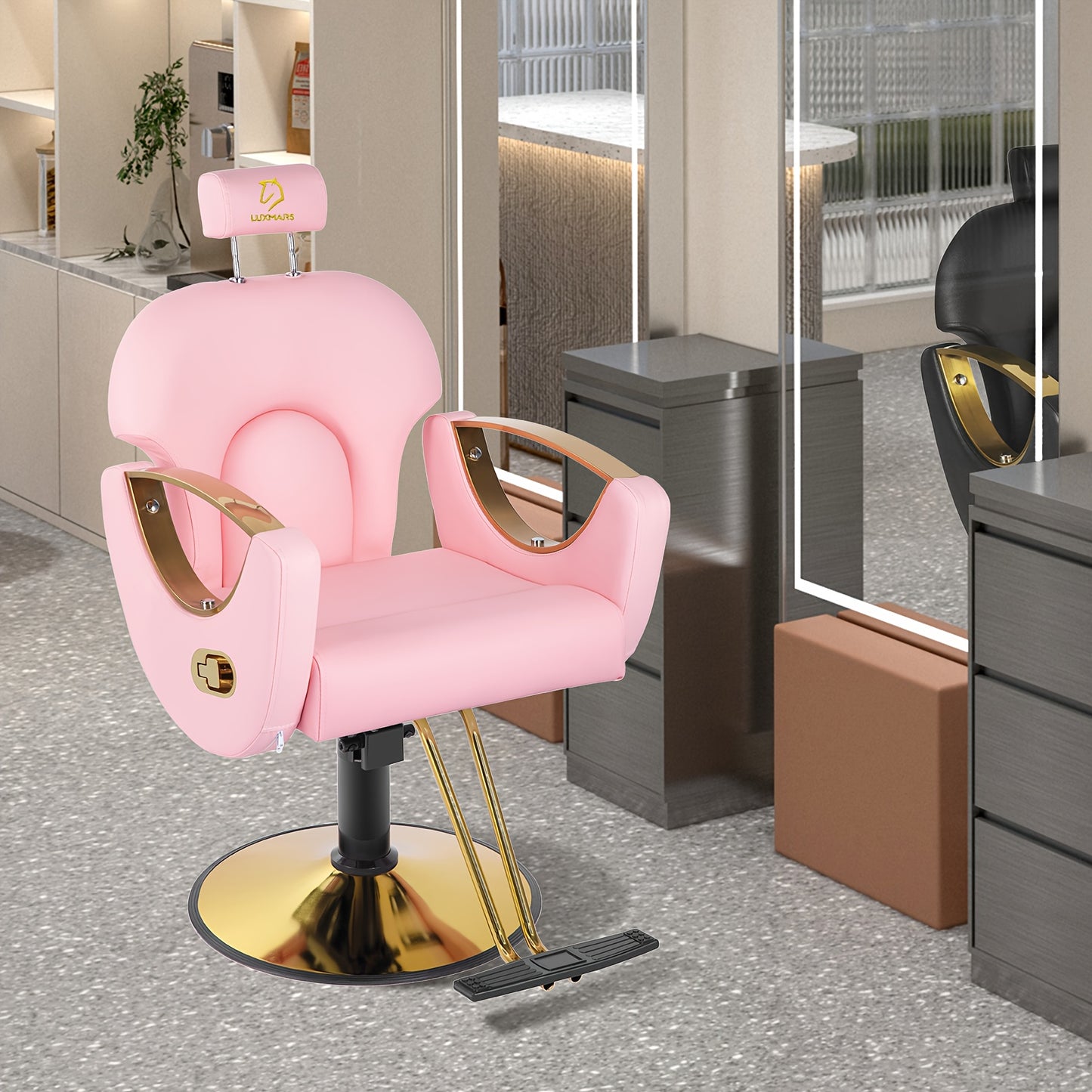 Pink reclining barber chair with gold accents in a modern salon setting