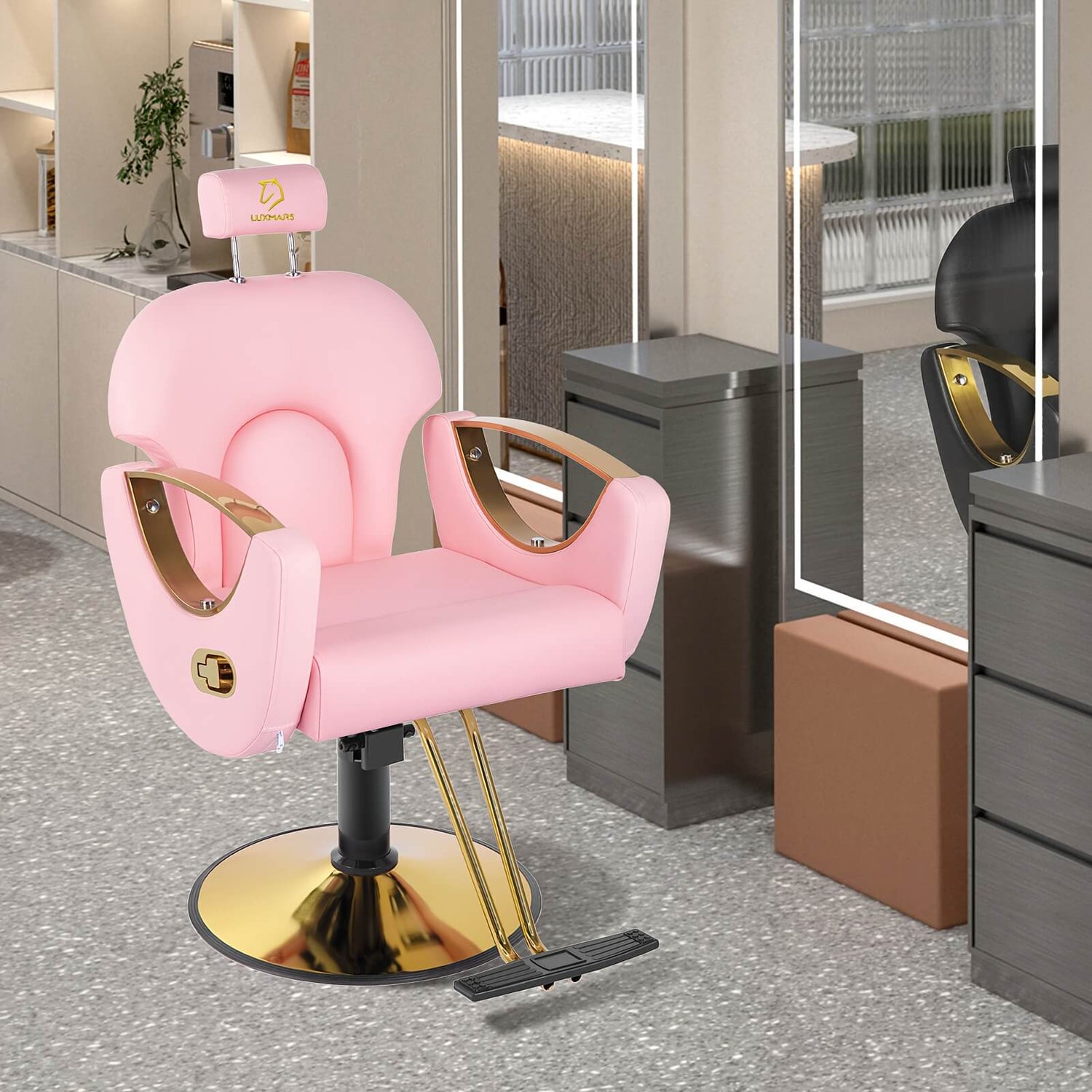 Pink reclining barber chair with gold accents in a modern salon setting