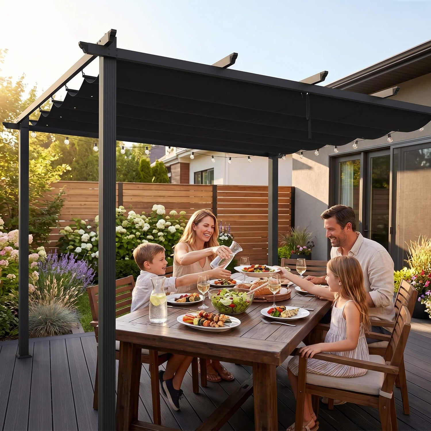 Family of four enjoying a meal outdoors under a black pergola.