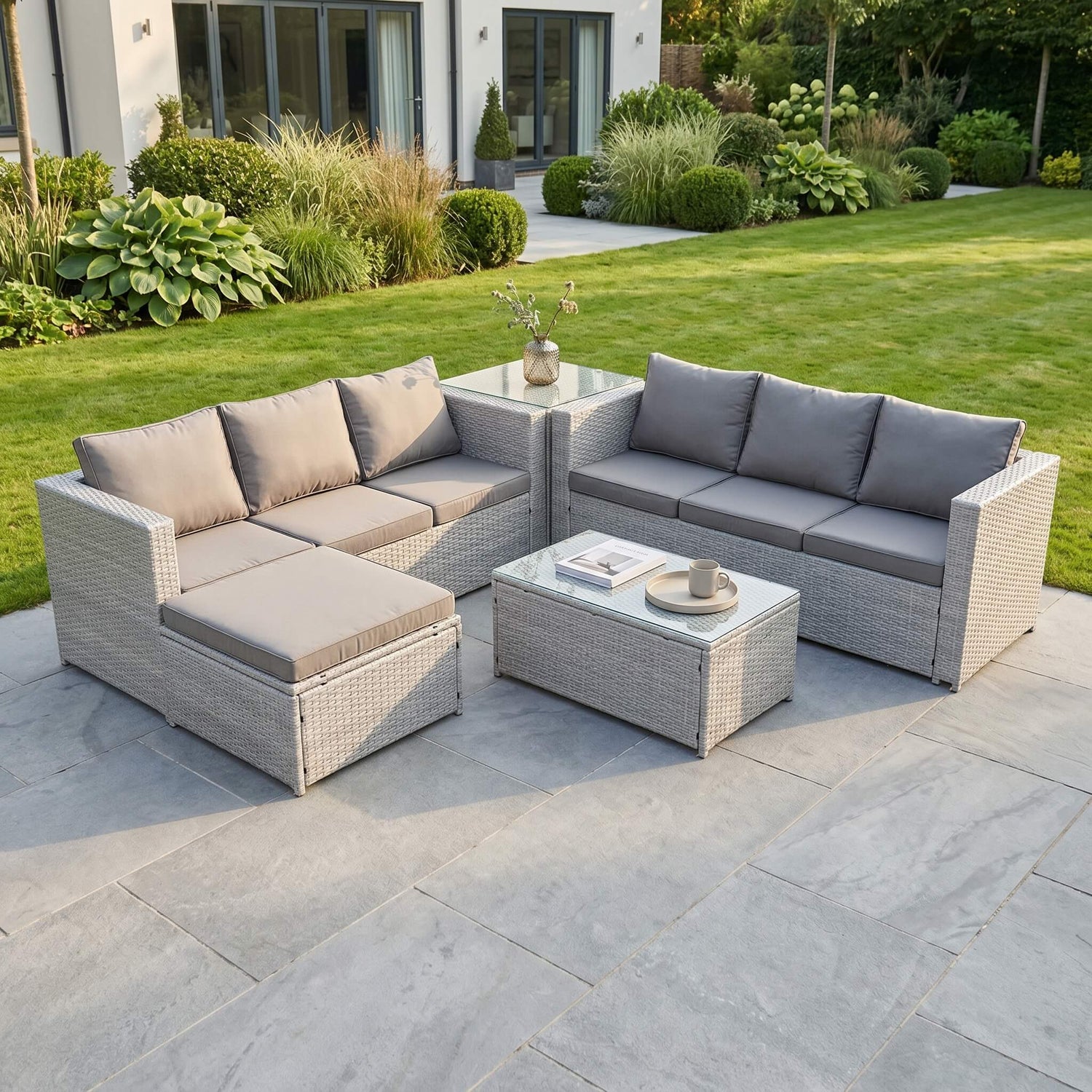 A Light Grey Outdoor Rattan Garden Furniture Set located in a patio
